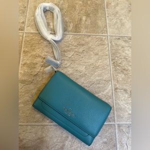 Brand new Kate Spade Crossbody wallet with strap.